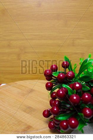Red Round Berry, Green Leaves On Brown Round Chopping Board
