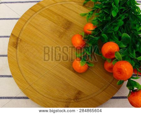 Red Round Berries, Fresh Ripe Juicy Orange Tangerines With Green Leaves, On A Round Wooden Board, Ho