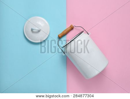 Enameled Milk Can On Blue Pink Pastel Background. Top View