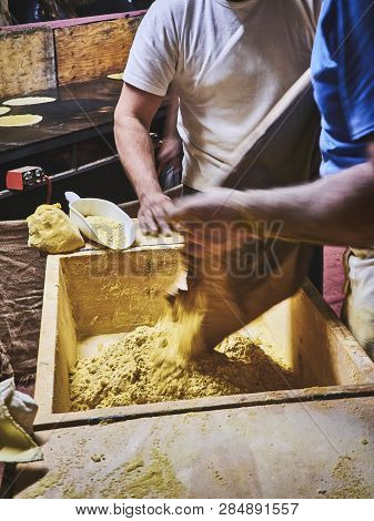 Cooks Making Dough For Tortillas On A Kneading Trough.