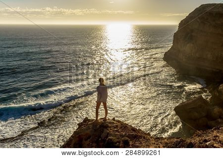 Jung Women Standing On Cliffs Near Port Lincon At Sunset, South Australia