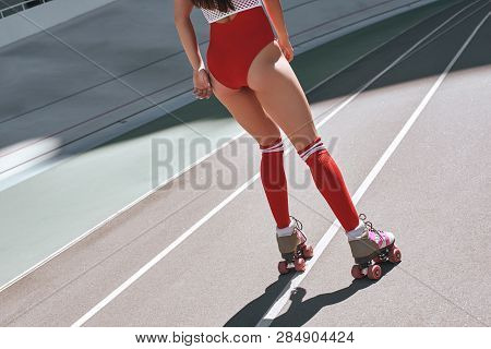 Think Less, Live More. Close Up Of Girls Legs In The Skatepark. She Is Rollerblading. Back View