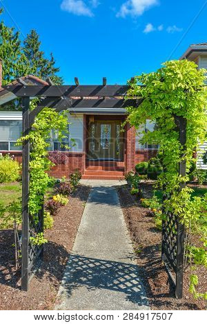 Entrance Of A House. Path Way Through The Arc To The Entrance Door