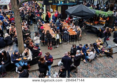 LONDON, UK - DECEMBER 30, 2018: Visitors at Camden Lock. Camden Lock, Camden Market, and streets nearby are the fourth-most popular attraction in the city, attracting 100,000 people each weekend