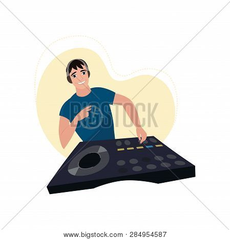 Young Smiling Male Dj In Headphones At Console With Vinyl Record Shows Victory Hand With Beige Light