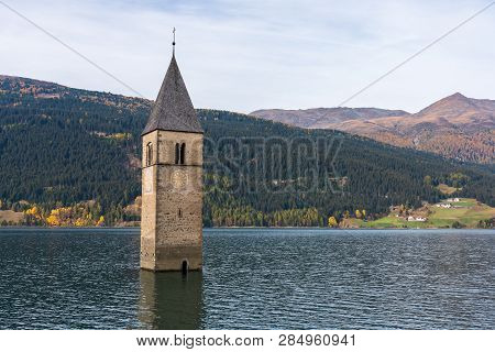 The Famous Bell Tower In The Lake Of Reschen - Lago Di Resia In South Tyrol, Italy. During Ww2 A Dam