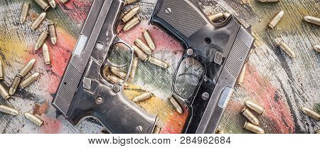 Top View Of Gun And Ammunition On The Table