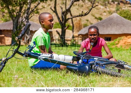 African Children Fixing A Puncture On A Bike
