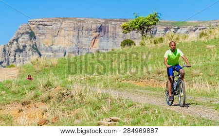 African Children Riding A Bike In Rural A Village