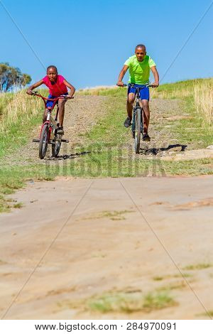 African Children Riding A Bike In Rural A Village
