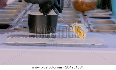 Chef Cooking Asian Natural Stir-fried Ice Cream Rolls At Freeze Pan. Outdoor Cooking, Gastronomy And