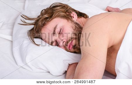 How Much Sleep You Actually Need. Man Handsome Guy Lay In Bed. Get Adequate And Consistent Amount Of