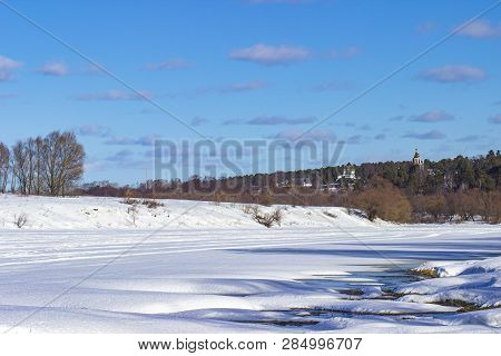 White snow on a small river in Russia in winter