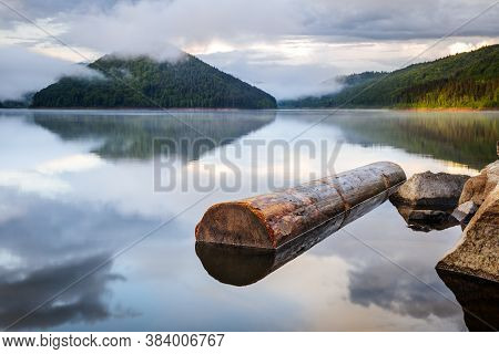 Mirror Smooth Water Of The Carpathian Zetelaka Lake. Beautyful Landscape After Rain