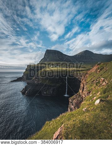 Gasadalur Village And Mulafossur Its Iconic Waterfall During Summer With Bluw Sky. Vagar, Faroe Isla