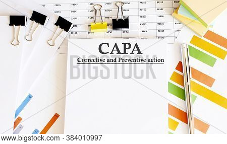 Paper With Corrective And Preventive Capa Action Plans On A Table