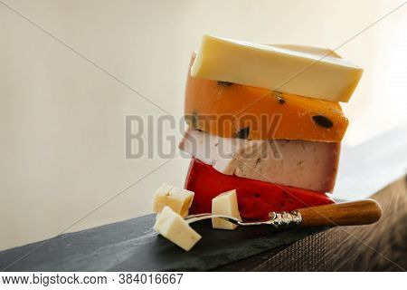 Different Types Of Delicious Cheeses And Fork On Slate Plate, Closeup. Space For Text