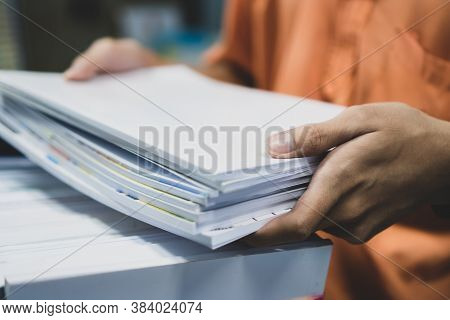 Office Workers Employee Holding Stacks Of Lot Documents Report Papers Waiting Be Managed On Desk In 