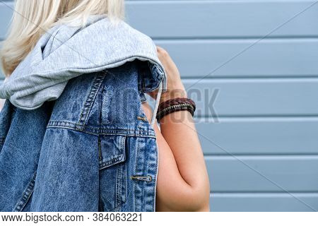 Hippie Woman Wearing Jeans, Denim Jacket And Boho Leather Accessories On A Hand Wrist, Bohemian Styl