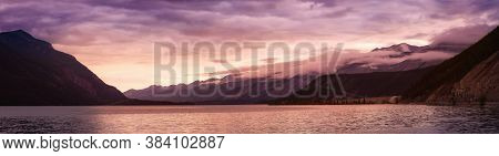 Beautiful Panoramic View Of Muncho Lake In The Canadian Northern Rockies During A Cloudy Sunrise. Ta
