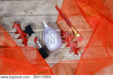 Perfume Bottle Lavender-colored,lipstick,bruch Lies Beautifully On A Wooden Background With Orange T