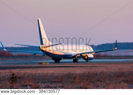 Passenger Airplane Taxiing On The Runway In The Early Morning