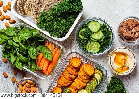 Preparing Healthy Meals For The Week. Vegan Food And Snacks In Containers, Gray Background. Flat Lay