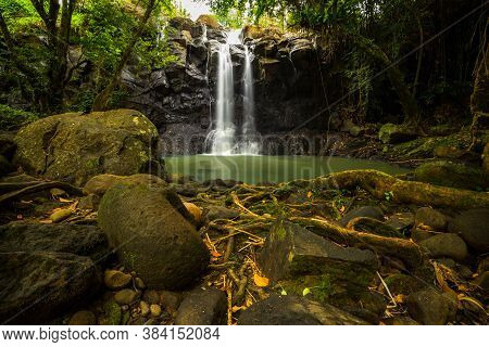 Tropical Landscape. Beautiful Hidden Waterfall In Rainforest. Adventure And Travel Concept. Nature B