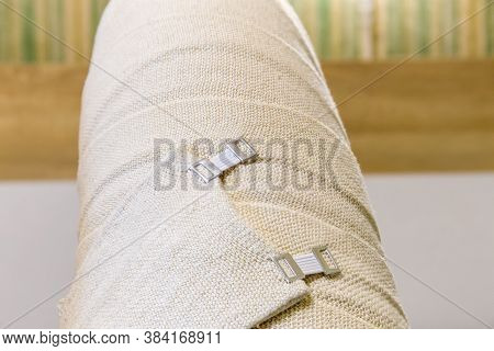 Human Thigh Of The Completely Wrapped Leg With Woven Elastic Medical Bandages And Fixed With Aluminu