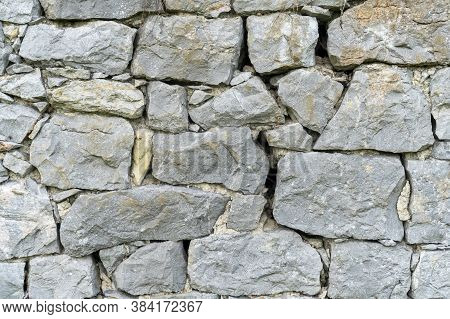 Rock Wall Background. Closeup. Copspace. Natural Gray Texture
