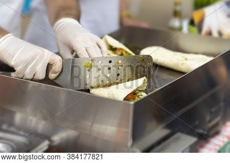 Hands Of Cook Close-up. Process Of Preparing A Quesadilla, Burrito, Fajitas. Outdoor Outside Setting