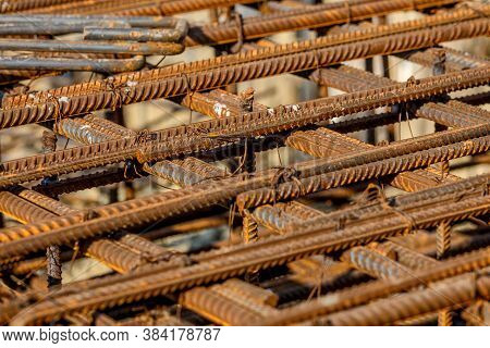 Steel Rebar For Reinforcement Concrete At Construction Site With House Under Construction Background
