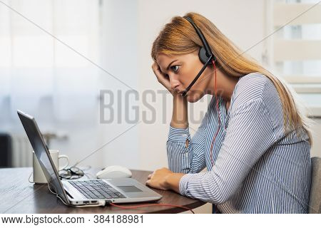 Young Modern Woman Is Working From Home. She Is Tired Of Using Computer All Day.