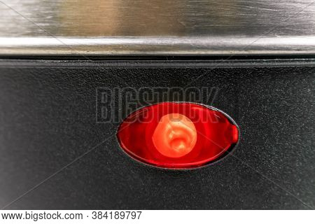 Lower Half Of A Grey Electric Kettle With A Red Light On, Macrophotograph