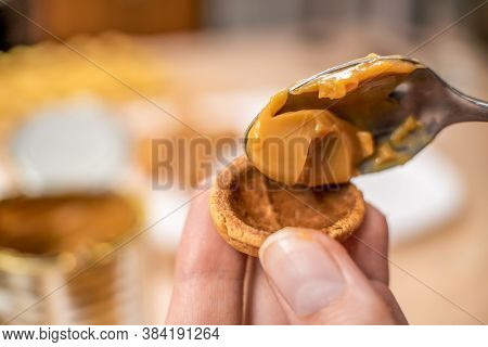Filling The Halves Of Cookie Nuts With Boiled Condensed Milk. Women's Hands Fill Cookies With Boiled