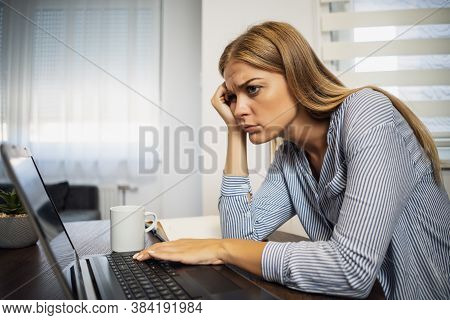 Young Modern Woman Is Working From Home. She Is Tired Of Using Computer All Day.