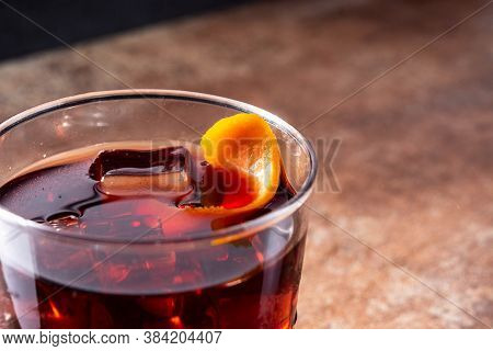 Boulevardier Cocktail And Orange Zest On Rusty Background. Copy Space