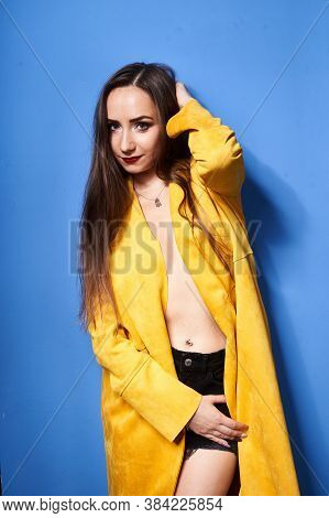 The Girl In The Yellow Coat Is Posing