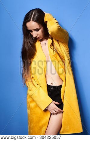 The Girl In The Yellow Coat Is Posing