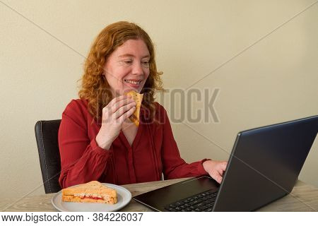 Causasian Woman Enjoying Breakfast Or Lunch While Working Or Learning At Home
