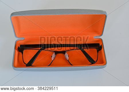 Spectacles In Orange Spectacle Case On White Table