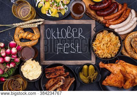 Oktoberfest Dishes: Beer, Pretzel, Sausage, Stewed Cabbage, Potato Salad, Half Of Chicken And Ribs