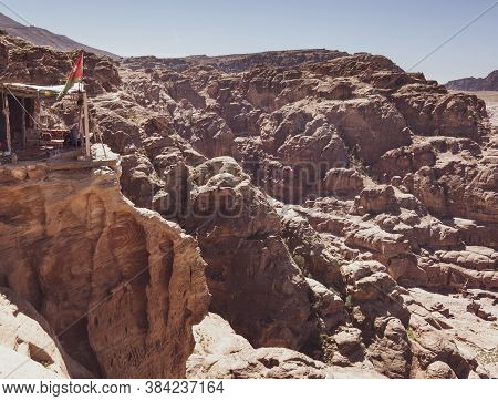 Tea House On A Cliff With The Flag Of Jordan In The Ancient City Of Petra