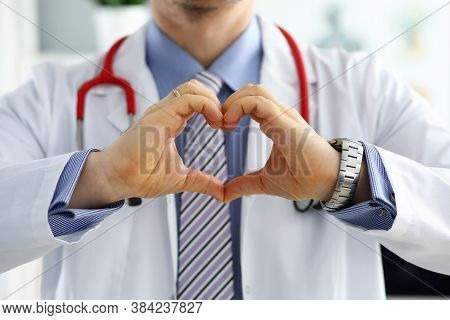 Male Medicine Doctor Hands Showing Heart Shape Closeup. Medical Help Prophylaxis Or Insurance Concep