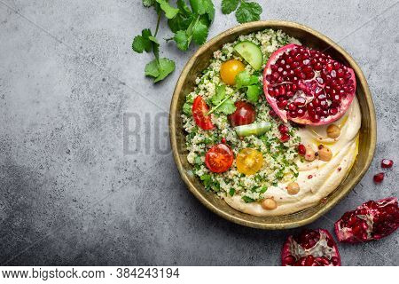 Rustic Bowl With Couscous Salad With Vegetables, Hummus And Fresh Cut Pomegranate. Middle Eastern Or