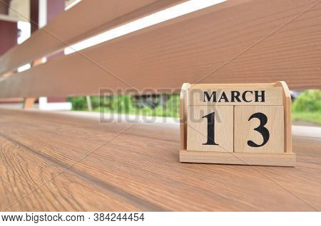 March 13, Number Cube With Wooden Balcony Background.