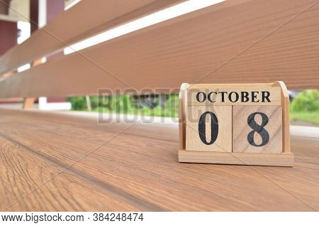 October 8, Number Cube With Wooden Balcony Background.