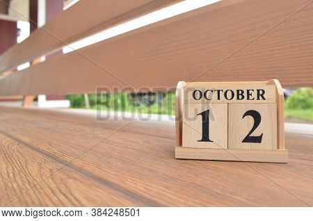 October 12, Number Cube With Wooden Balcony Background.
