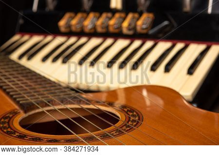 Old Accordion And A Beautiful Guitar Composing A Scene On A Rustic Wooden Surface With Black Backgro
