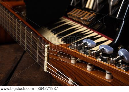 Old Accordion And A Beautiful Guitar Composing A Scene On A Rustic Wooden Surface With Black Backgro